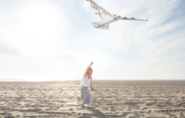 young adult having fun with kite