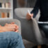 woman with hands together talking with counselor